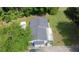 Aerial view of a cozy home surrounded by lush greenery, featuring a dark roof and a spacious, paved driveway at 3184 Newcastle Way, Snellville, GA 30039