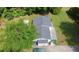Aerial view of a well-maintained home with lush greenery, a dark roof, and a spacious, paved driveway at 3184 Newcastle Way, Snellville, GA 30039
