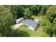 Aerial view of a charming home with lush greenery, RV parking, and a cozy porch at 3184 Newcastle Way, Snellville, GA 30039