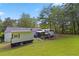 Expansive backyard with lush lawn, mature trees, and various outdoor recreational amenities at 3184 Newcastle Way, Snellville, GA 30039