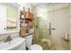 Clean bathroom showcasing a glass-enclosed shower, vanity, and shelving unit at 3184 Newcastle Way, Snellville, GA 30039