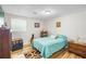 Well-lit bedroom with wood floors, decorative accents, and a comfortable bed at 3184 Newcastle Way, Snellville, GA 30039