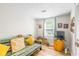 Comfortable bedroom with a daybed, window, and wood laminate flooring at 3184 Newcastle Way, Snellville, GA 30039