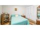 Bright bedroom featuring neutral walls, wood floors, and a double-door closet at 3184 Newcastle Way, Snellville, GA 30039