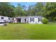 Charming one-story home with a large, well-maintained lawn and a recreational vehicle parked in the driveway at 3184 Newcastle Way, Snellville, GA 30039