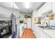 Galley-style kitchen featuring stainless steel appliances and white cabinetry at 3184 Newcastle Way, Snellville, GA 30039