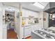 Kitchen view featuring a convenient pantry, white appliances, and ample counter space at 3184 Newcastle Way, Snellville, GA 30039