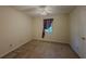 Bedroom featuring a ceiling fan, carpeted floors, and a window with a curtain at 5334 Post Road Pass, Stone Mountain, GA 30088