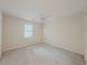 Bright bedroom with neutral walls and carpeting, plus a window and ceiling fan at 5334 Post Road Pass, Stone Mountain, GA 30088