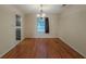 Dining room with hardwood floors, chandelier, and a view into the kitchen, perfect for entertaining guests at 5334 Post Road Pass, Stone Mountain, GA 30088