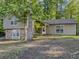 Charming home featuring stone accents, neutral paint, and a welcoming front entrance, nestled among mature trees at 5334 Post Road Pass, Stone Mountain, GA 30088