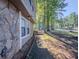 View of the stone and siding exterior of a home, showcasing the walkway and surrounding landscape at 5334 Post Road Pass, Stone Mountain, GA 30088