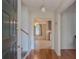 Inviting foyer featuring hardwood floors, a staircase, and a glimpse into the adjacent living spaces at 5334 Post Road Pass, Stone Mountain, GA 30088
