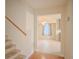 Bright hallway features hardwood floors and views into the kitchen at 5334 Post Road Pass, Stone Mountain, GA 30088