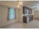 Bright kitchen features neutral cabinets, tile floors, modern lighting, and a window at 5334 Post Road Pass, Stone Mountain, GA 30088