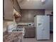 Traditional kitchen features a white refrigerator and range oven and matching brown cabinets at 5334 Post Road Pass, Stone Mountain, GA 30088