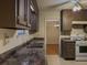 Kitchen with stainless steel sink, ample cabinets, modern appliances, and a view into the dining area at 5334 Post Road Pass, Stone Mountain, GA 30088