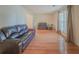 Spacious living area with hardwood floors, plenty of seating, and natural light from the windows at 5334 Post Road Pass, Stone Mountain, GA 30088