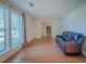 Bright and airy living room with hardwood floors, large windows, and a comfortable leather couch at 5334 Post Road Pass, Stone Mountain, GA 30088