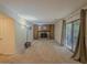 Spacious carpeted living room with fireplace and sliding glass doors to the backyard at 5334 Post Road Pass, Stone Mountain, GA 30088