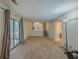 Spacious living room with sliding glass door and view of the downstairs and the bathroom at 5334 Post Road Pass, Stone Mountain, GA 30088