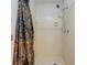 Tiled shower stall with adjustable shower head and a colorful curtain at 5334 Post Road Pass, Stone Mountain, GA 30088