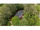 An aerial view of the home featuring lush green landscaping and trees at 605 Buttercup Trce, Johns Creek, GA 30022