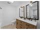 Updated bathroom with a double sink vanity, framed mirrors, and modern fixtures at 605 Buttercup Trce, Johns Creek, GA 30022