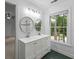 Bright bathroom featuring double sinks and a tiled shower visible through the doorway at 605 Buttercup Trce, Johns Creek, GA 30022
