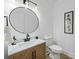 Modern bathroom with stylish vanity, round mirror, and neutral color scheme at 605 Buttercup Trce, Johns Creek, GA 30022