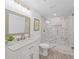 Modern bathroom with gray tiling in the glass shower and a white vanity at 605 Buttercup Trce, Johns Creek, GA 30022