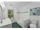 Well-lit bathroom with dual sinks, shower-tub combo, and a window at 605 Buttercup Trce, Johns Creek, GA 30022