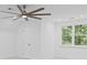 Spacious bedroom with a modern ceiling fan and scenic outdoor views at 605 Buttercup Trce, Johns Creek, GA 30022