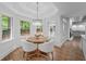 Cozy breakfast nook with a view to the backyard, modern chandelier and access to the kitchen at 605 Buttercup Trce, Johns Creek, GA 30022