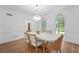 Elegant dining room featuring a modern chandelier, decorative wainscoting, and neutral decor at 605 Buttercup Trce, Johns Creek, GA 30022