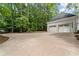 Spacious driveway leading to a two-car garage, providing ample parking space for residents and guests at 605 Buttercup Trce, Johns Creek, GA 30022
