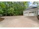 A two car garage with a long driveway at 605 Buttercup Trce, Johns Creek, GA 30022