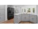 Modern kitchen with gray cabinets, black appliances, marble countertops, and a breakfast nook at 605 Buttercup Trce, Johns Creek, GA 30022
