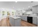 Bright kitchen with granite counters, stainless appliances, hardwood floors, and a bay window at 605 Buttercup Trce, Johns Creek, GA 30022