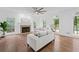 Bright living room with fireplace, large windows, hardwood floors, and comfortable seating at 605 Buttercup Trce, Johns Creek, GA 30022
