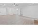 Spacious living room with luxury floors, white paint and access to the bathroom and stairs at 605 Buttercup Trce, Johns Creek, GA 30022
