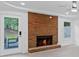 Living room with brick fireplace and access to backyard at 605 Buttercup Trce, Johns Creek, GA 30022