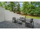 Private patio featuring contemporary outdoor seating, perfect for relaxation and entertaining in a serene setting at 605 Buttercup Trce, Johns Creek, GA 30022