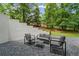Outdoor patio with gravel and modern chairs with a matching table at 605 Buttercup Trce, Johns Creek, GA 30022