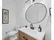 Stylish powder room features modern fixtures, vanity, and a round mirror at 605 Buttercup Trce, Johns Creek, GA 30022