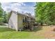 View of the backyard with a deck, patio area, and green lawn. Outdoor entertaining spaces. Mature trees at 709 Eastwood Rise, Stone Mountain, GA 30087