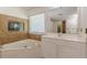 Bright bathroom with a large soaking tub and a window at 709 Eastwood Rise, Stone Mountain, GA 30087