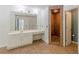 The ensuite bathroom offers a huge mirror, vanity, and tiled shower at 709 Eastwood Rise, Stone Mountain, GA 30087