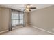 Neutral bedroom featuring natural light, a ceiling fan, and soft curtains, ideal for creating a relaxing space at 709 Eastwood Rise, Stone Mountain, GA 30087