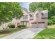 Charming brick home with a two-car garage and a well-maintained front lawn and traditional architectural details at 709 Eastwood Rise, Stone Mountain, GA 30087